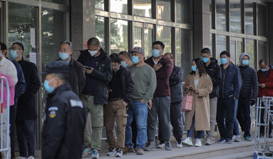 People queueing to get Covid-19 vaccine booster shots at a vaccination centre in Beijing